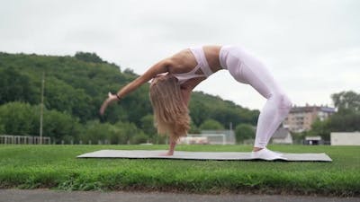 Woman doing gymnastic exercises in the stadium.