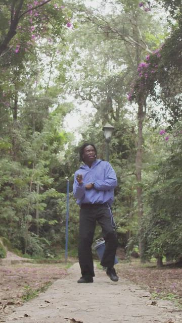 Cheerful man moves forward dancing in the middle of nature.