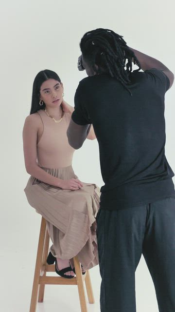 Photographer portraying a woman on a white background.