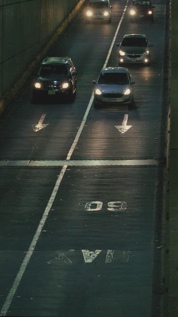 Two avenues with many cars traveling at night.