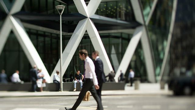 People walking in front of a building.