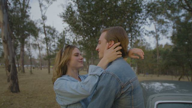 Romantic couple embracing in the middle of a forest.